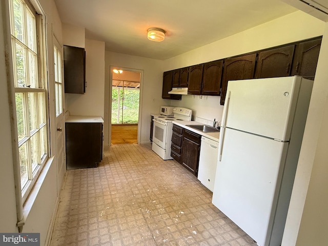 12909 Cohasset Ln, Woodbridge, VA 22192 - kitchen with white appliances, a sink, dark brown cabinets, and light countertops