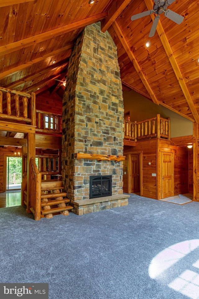 821 Sand Ridge Rd, Howard, PA 16841 - unfurnished living room featuring carpet, wooden ceiling, high vaulted ceiling, a stone fireplace, and beamed ceiling
