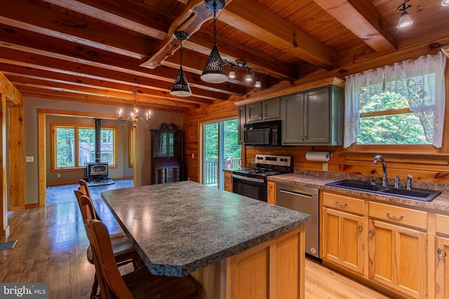 821 Sand Ridge Rd, Howard, PA 16841 - kitchen with stainless steel appliances, a sink, a wood stove, wooden ceiling, and light wood-style floors