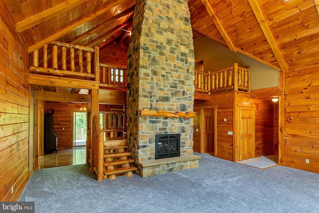 821 Sand Ridge Rd, Howard, PA 16841 - unfurnished living room with wooden walls, high vaulted ceiling, carpet floors, and a fireplace