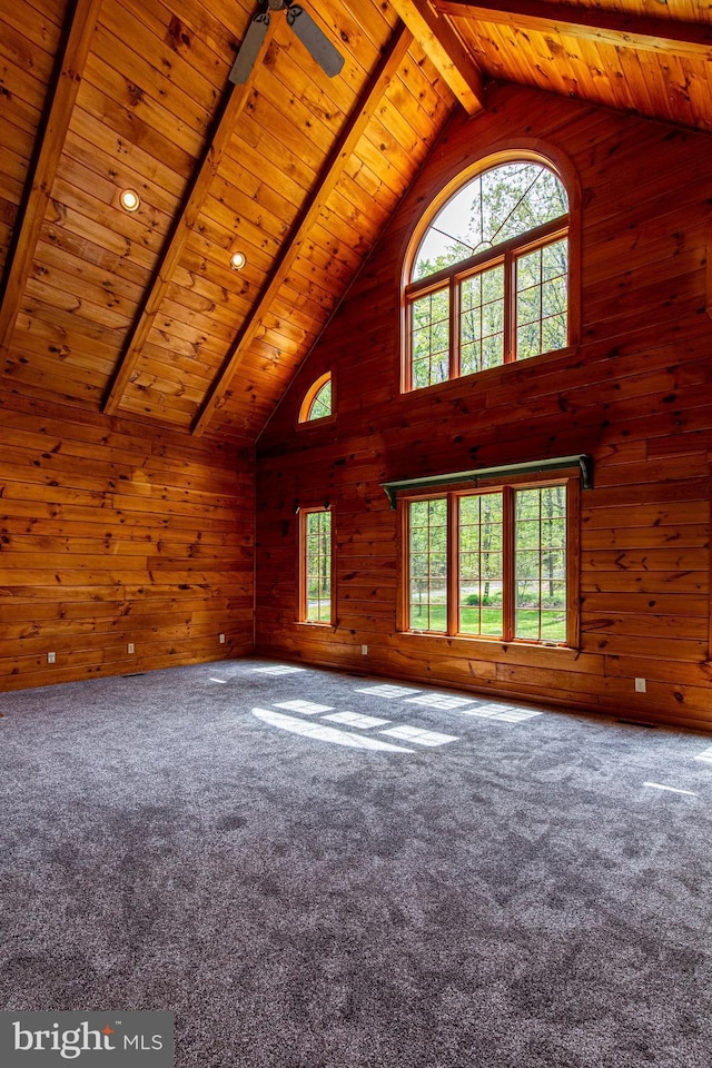 821 Sand Ridge Rd, Howard, PA 16841 - unfurnished living room featuring wooden walls, high vaulted ceiling, carpet floors, wood ceiling, and beam ceiling