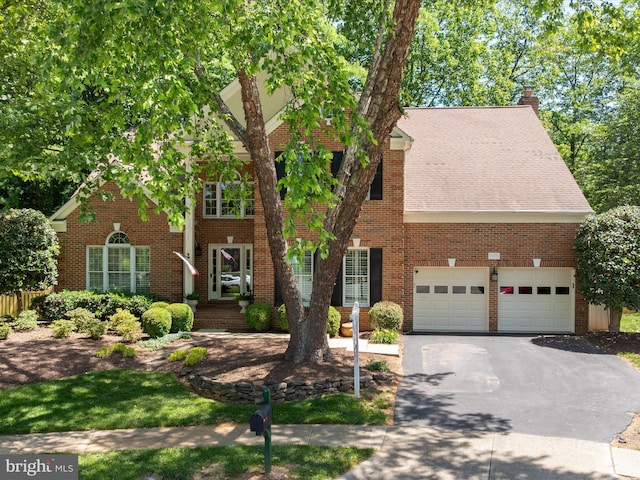 12906 Brafferton Ct, Herndon, VA 20171 - view of front facade with asphalt driveway, a chimney, brick siding, and a shingled roof