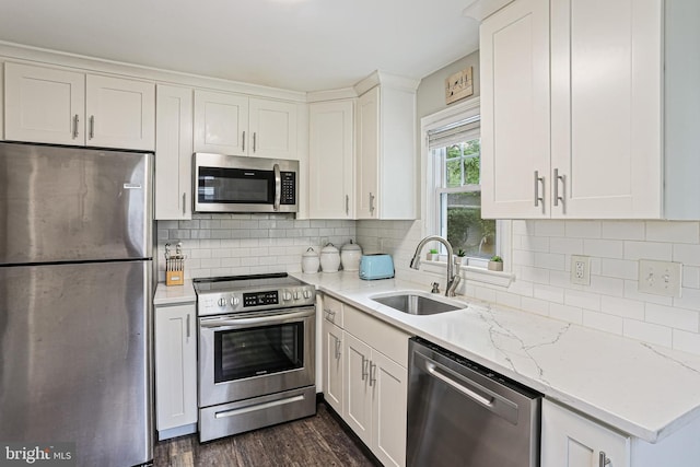 621 Jumpers Hole Rd, Severna Park, MD 21146 - kitchen with appliances with stainless steel finishes, a sink, white cabinetry, light stone countertops, and dark wood-type flooring