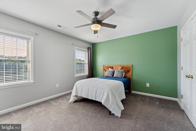 carpeted bedroom featuring baseboards and ceiling fan