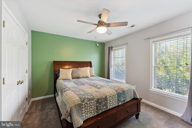 bedroom with carpet flooring, multiple windows, and baseboards