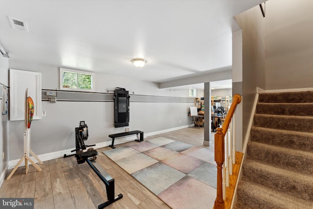 workout room featuring wood finished floors and baseboards