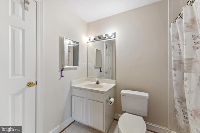 bathroom featuring baseboards, toilet, vanity, tile patterned floors, and a shower with curtain