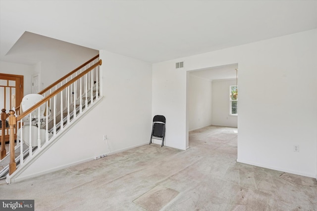 7 Gazelle Pl, New Castle, DE 19720 - unfurnished living room with stairs, carpet flooring, and baseboards