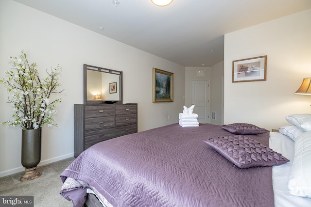 carpeted bedroom featuring baseboards