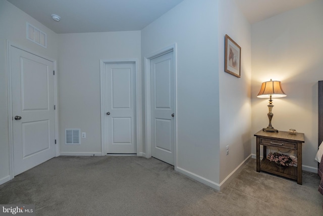 bedroom with light colored carpet and baseboards