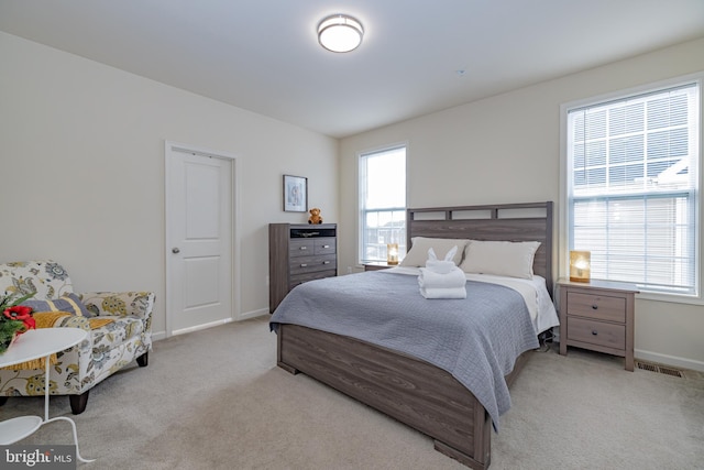 bedroom with multiple windows, carpet flooring, and baseboards
