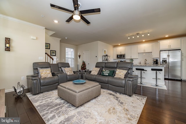 living area featuring a ceiling fan, dark wood-style floors, stairs, ornamental molding, and recessed lighting