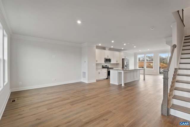 2 Talen Ln, Charlottesville, VA 22911 - unfurnished living room with stairway, ornamental molding, baseboards, recessed lighting, and light wood-style floors
