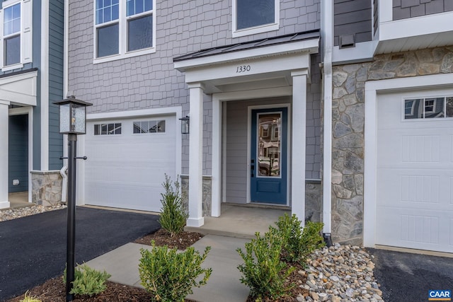 2 Talen Ln, Charlottesville, VA 22911 - view of exterior entry with stone siding, an attached garage, and driveway