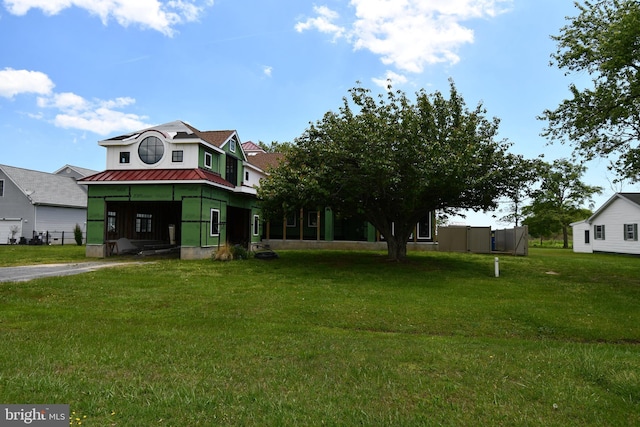 6222 S Point Rd, Berlin, MD 21811 - view of front of house featuring a front lawn, metal roof, and stucco siding