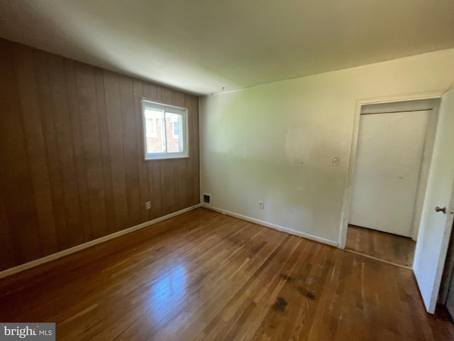 3208 28th Pkwy, Temple Hills, MD 20748 - unfurnished room featuring wood finished floors, baseboards, and wooden walls
