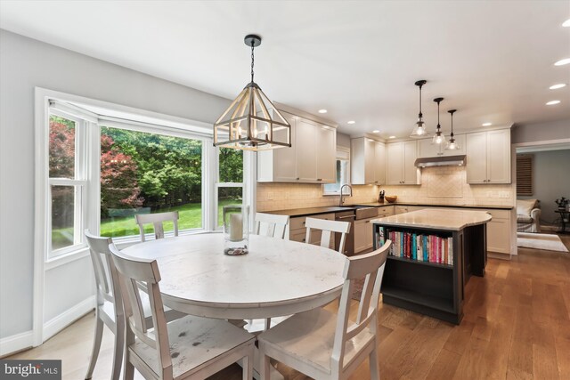 11476 Bronzedale Dr, Oakton, VA 22124 - dining area with light wood-style flooring, a chandelier, recessed lighting, and baseboards