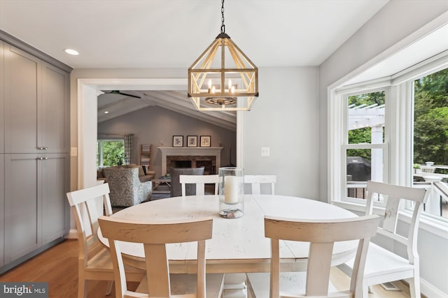 11476 Bronzedale Dr, Oakton, VA 22124 - dining space featuring light wood-type flooring, a chandelier, vaulted ceiling, and recessed lighting
