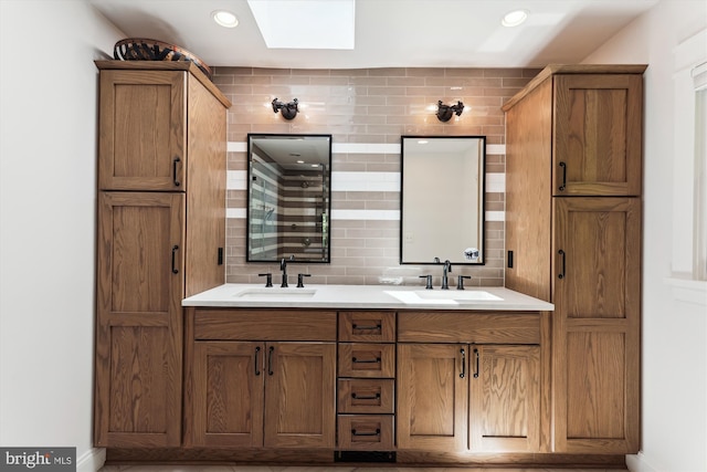 11476 Bronzedale Dr, Oakton, VA 22124 - full bath featuring a skylight, decorative backsplash, double vanity, baseboards, and recessed lighting