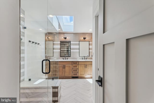 11476 Bronzedale Dr, Oakton, VA 22124 - bathroom featuring a skylight, double vanity, and a shower stall
