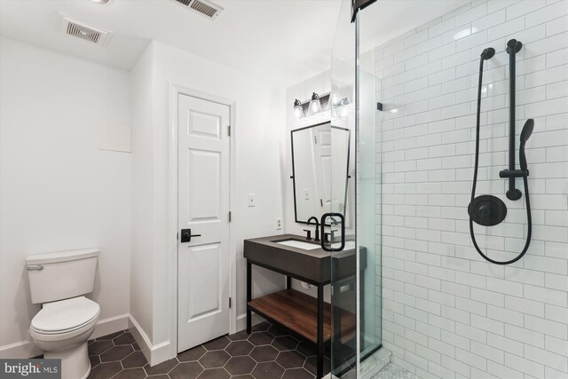 11476 Bronzedale Dr, Oakton, VA 22124 - bathroom with a shower stall, toilet, tile patterned floors, vanity, and baseboards