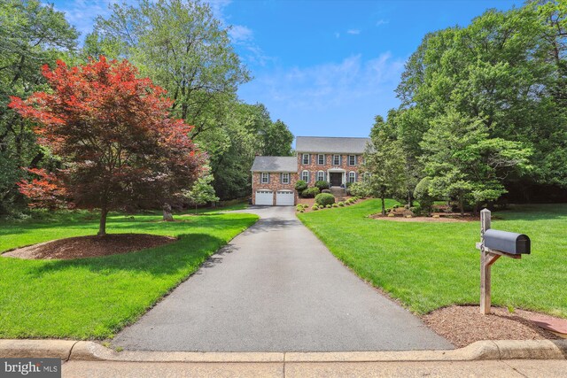 11476 Bronzedale Dr, Oakton, VA 22124 - colonial-style house with a garage, a front lawn, and driveway