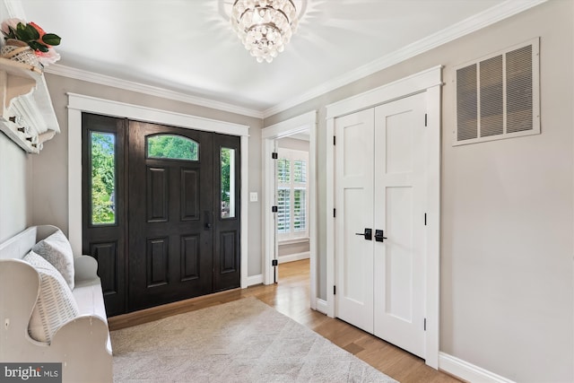 11476 Bronzedale Dr, Oakton, VA 22124 - entrance foyer featuring a chandelier, wood finished floors, baseboards, and crown molding