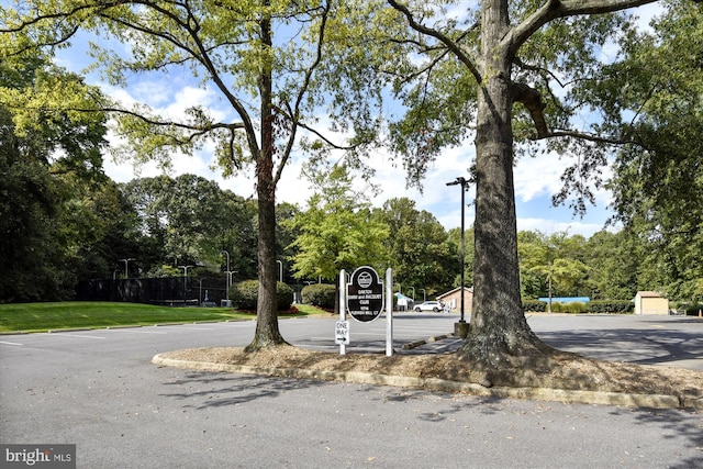 11476 Bronzedale Dr, Oakton, VA 22124 - view of asphalt road featuring curbs, view of scattered trees, and street lights