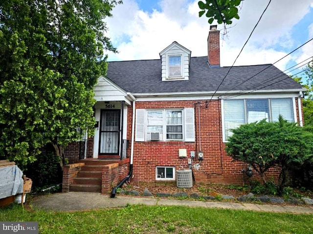 5614 54th Ave, Riverdale, MD 20737 - view of front of property with a chimney, brick siding, central AC, and a shingled roof