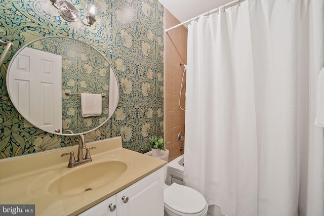 bathroom with wallpapered walls, toilet, vanity, and shower / bath combination with curtain