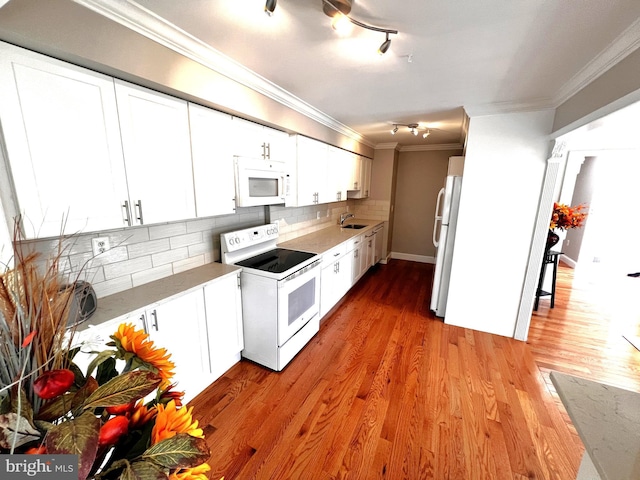 6572 Flagmaker Ct, Falls Church, VA 22042 - kitchen with white appliances, ornamental molding, decorative backsplash, light countertops, and white cabinetry