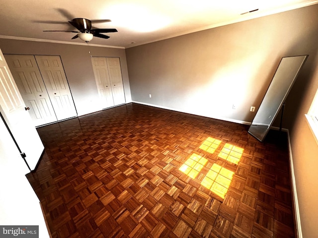 6572 Flagmaker Ct, Falls Church, VA 22042 - unfurnished bedroom with two closets, baseboards, crown molding, and a ceiling fan