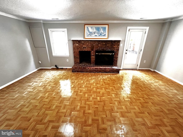 6572 Flagmaker Ct, Falls Church, VA 22042 - unfurnished living room featuring baseboards, a textured ceiling, ornamental molding, and a brick fireplace