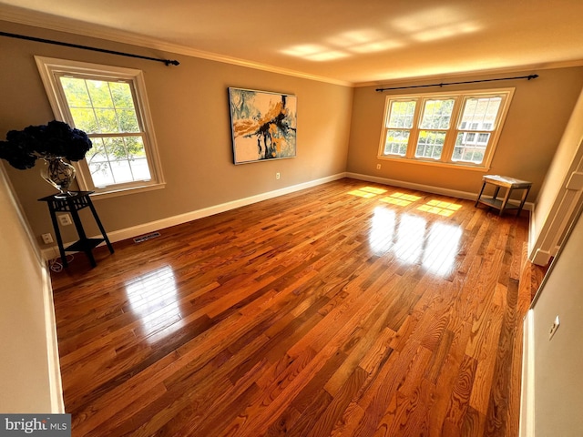 6572 Flagmaker Ct, Falls Church, VA 22042 - empty room featuring healthy amount of natural light, ornamental molding, wood finished floors, and baseboards