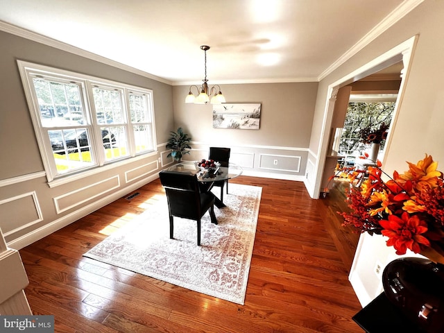 6572 Flagmaker Ct, Falls Church, VA 22042 - dining space featuring a chandelier, healthy amount of natural light, ornamental molding, a decorative wall, and wood finished floors
