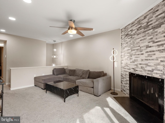 living area with ceiling fan, carpet floors, recessed lighting, baseboards, and a fireplace