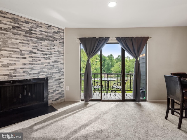 carpeted living room with baseboards and a tile fireplace