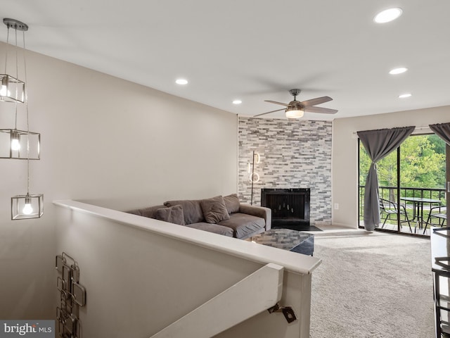 living area with ceiling fan, recessed lighting, carpet flooring, and a large fireplace