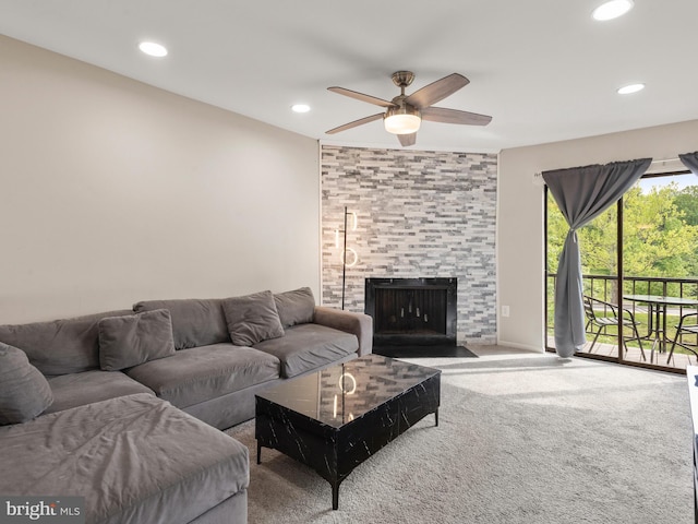 living room featuring a ceiling fan, carpet floors, recessed lighting, and a fireplace