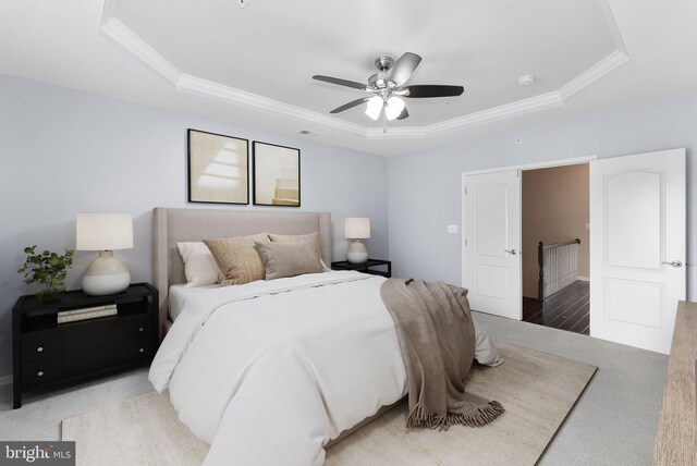 23483 Aldie Manor Ter, Ashburn, VA 20148 - carpeted bedroom featuring a tray ceiling, crown molding, and a ceiling fan