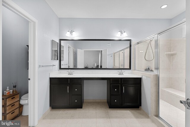 23483 Aldie Manor Ter, Ashburn, VA 20148 - full bath featuring a stall shower, tile patterned flooring, toilet, and double vanity