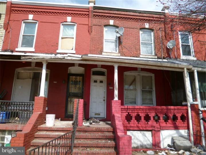 5113 W Girard Ave, Philadelphia, PA 19131 - townhome / multi-family property with a porch and brick siding