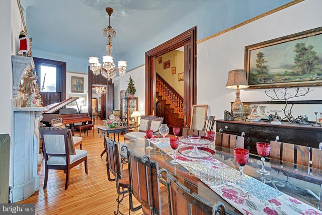 226 S 5th St, Reading, PA 19602 - dining space featuring a chandelier, stairs, and wood finished floors