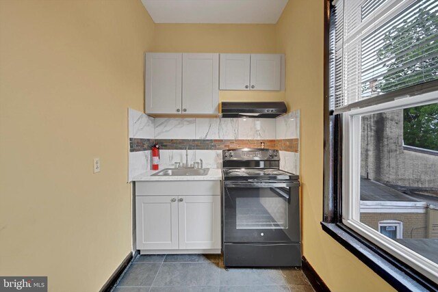 226 S 5th St, Reading, PA 19602 - kitchen featuring black electric range oven, range hood, a sink, decorative backsplash, and light countertops