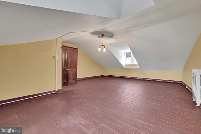 226 S 5th St, Reading, PA 19602 - additional living space with vaulted ceiling, dark wood-type flooring, and baseboards