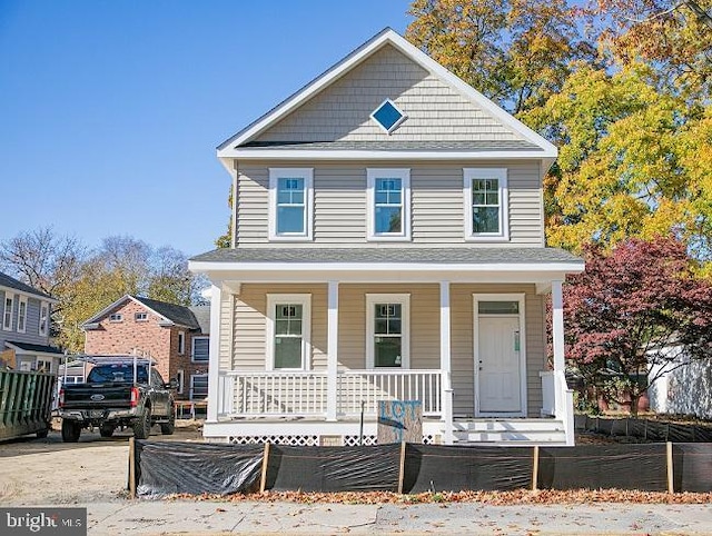 view of front facade with a porch and fence