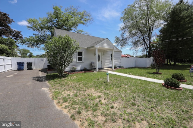 view of front of house featuring a shingled roof and asphalt driveway