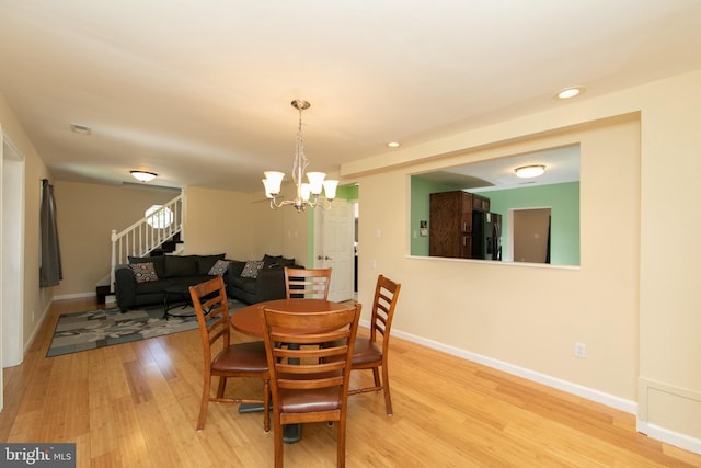 dining room featuring light wood-style flooring, stairs, a chandelier, baseboards, and recessed lighting