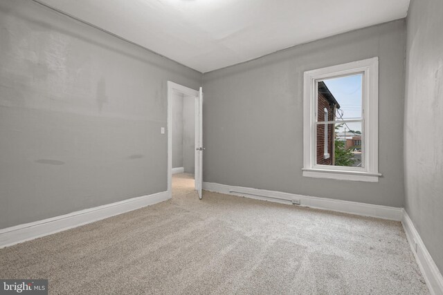 carpeted spare room with baseboards