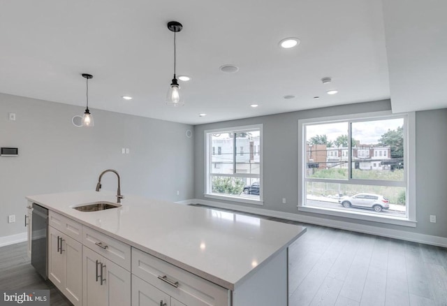 1309 S 52nd St, Philadelphia, PA 19143 - kitchen with a sink, baseboards, white cabinets, light countertops, and recessed lighting